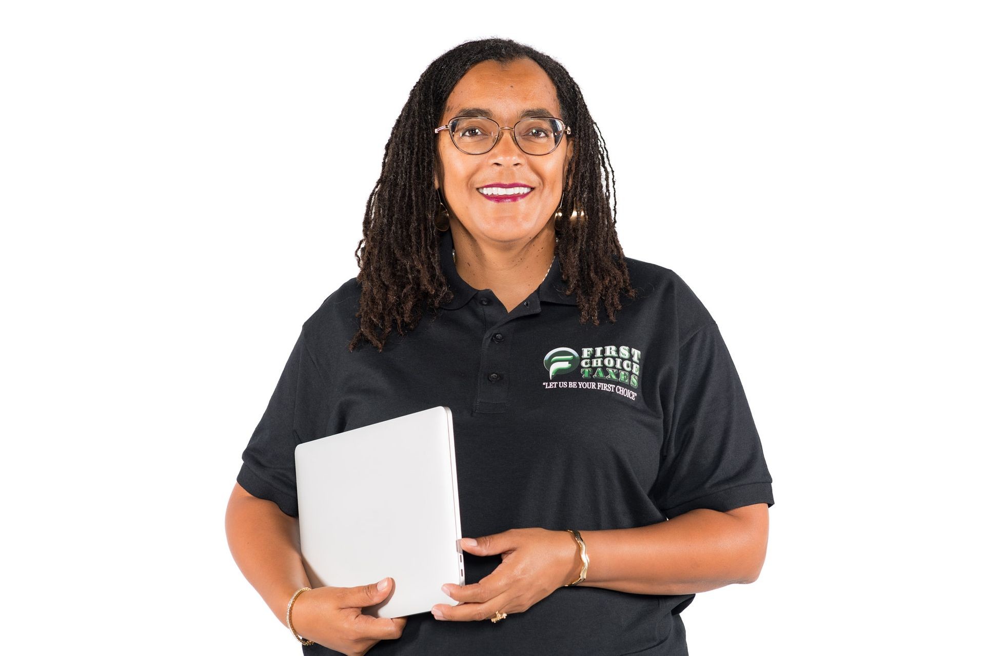 Person wearing a black polo shirt with an embroidered logo holding a closed laptop against a white background.