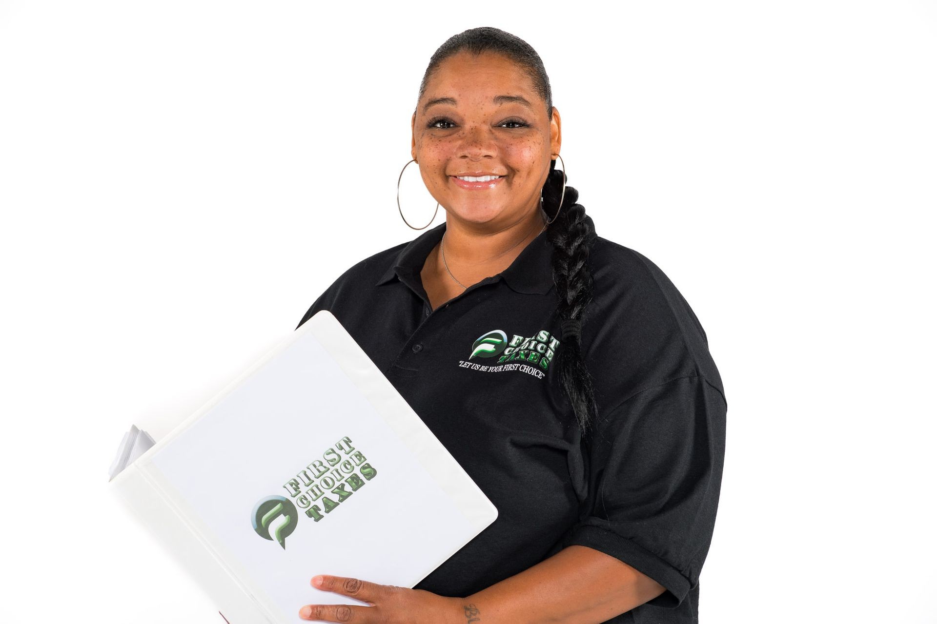 Smiling person in a black polo shirt holding a binder with 'First Choice Taxes' logo.